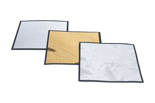 3 different light modifiers lined up on top of each other, two are silver and one is gold.